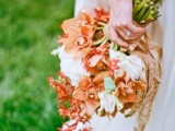 a bright wedding bouquet of orange and white blooms, with a cool dimension and plenty of texture is awesome for summer or fall