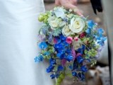 a bright wedding bouquet of light and bold blue blooms and white ones, with lots of texture and thistles is amazing for spring or summer