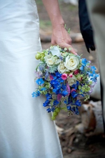 a bright wedding bouquet of light and bold blue blooms and white ones, with lots of texture and thistles is amazing for spring or summer
