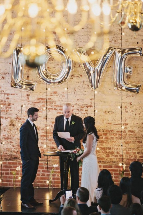 hanging lights and a silver letter balloon backdrop is a pretty solution for many types of weddings and all the seasons