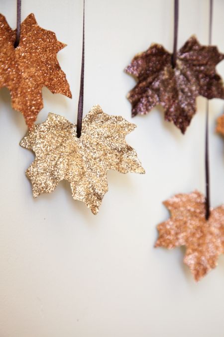 fall-colored glitter faux leaves hanging down are a great and very easy to make fall wedding backdrop