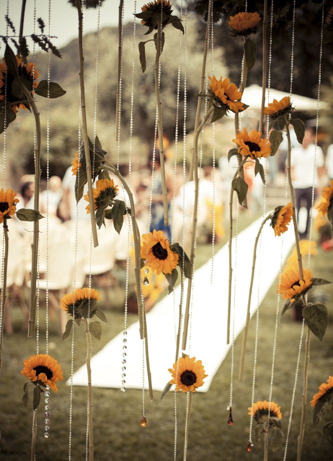 A backdrop of hanging crystals and sunflowers is a lovely idea for the fall and it will easily match a rustic or a farmhouse wedding