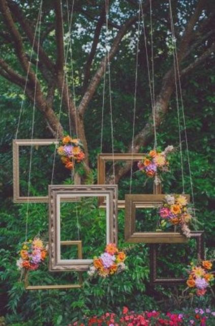 a refined empty frame wedding backdrop with bold blooms is a unique idea suitable for a fine art fall wedding