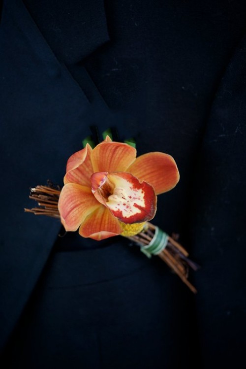 a bright rust-colored wedding boutonniere with twigs is a lovely and stylish diea for a fall groom