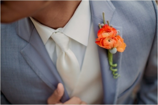 a brigth orange bloom wedding boutonniere with berries is timeless classics for a fall wedding