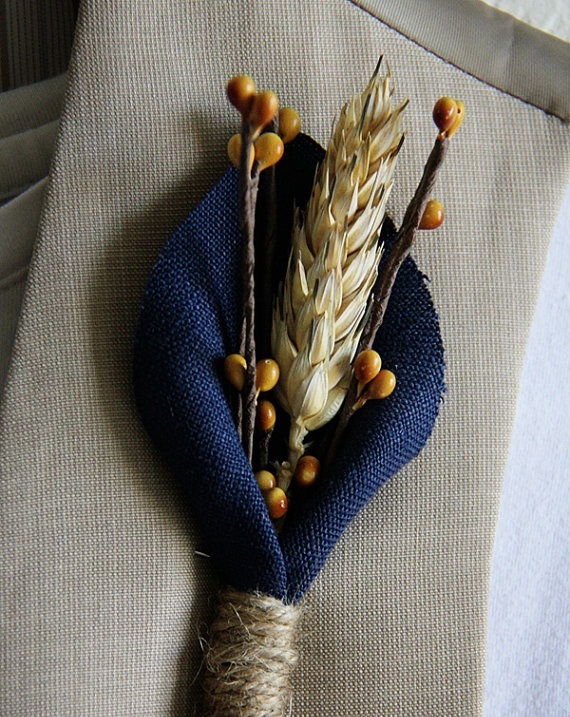 a rustic fall wedding boutonniere with navy fabric, faux berries, a spike for a rustic fall wedding