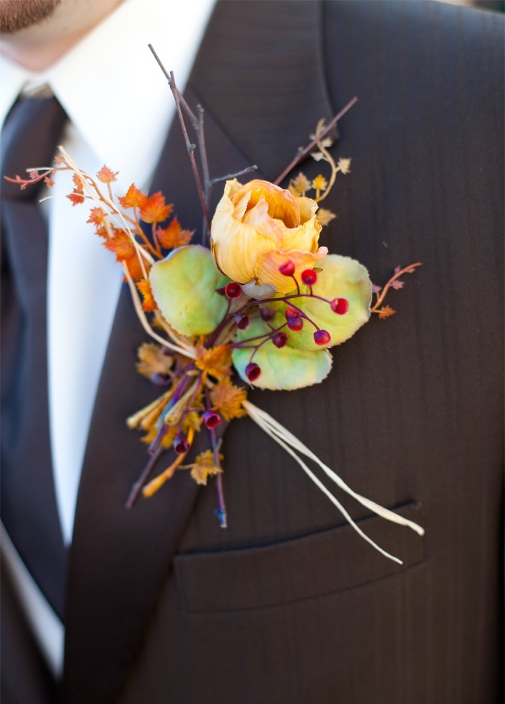 a bold fall wedding boutonniere with fall leaves, a bright bloom and berries is a stylish and cool idea for a bright fall wedding