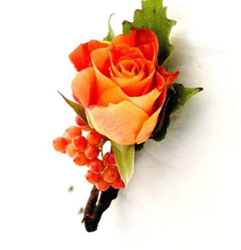a bright fall wedding boutonniere with berries and an orange rose plus leaves is a stylish idea