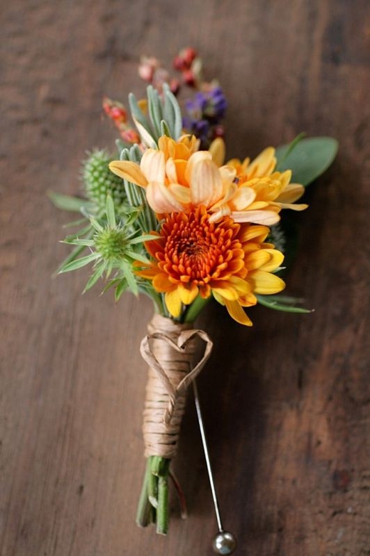 a bright fall wedding boutonniere with orange, yellow and lilac blooms and thistles is a bright idea for a rustic fall wedding