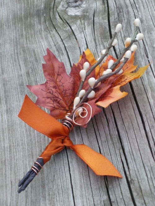 a bold fall wedding boutonniere of bright leaves, faux berries, rust ribbon and copper wire