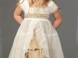 a tan underdress, a white tulle overdress with ruffles and pleats for an unusual and boho look