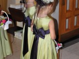 green A-line flower girl dress with black sashes and bows are a cute touch of color and look classic