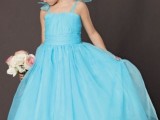 a blue A-line maxi dress with bows on the shoulders, a floral crown for a beautiful flower girl look