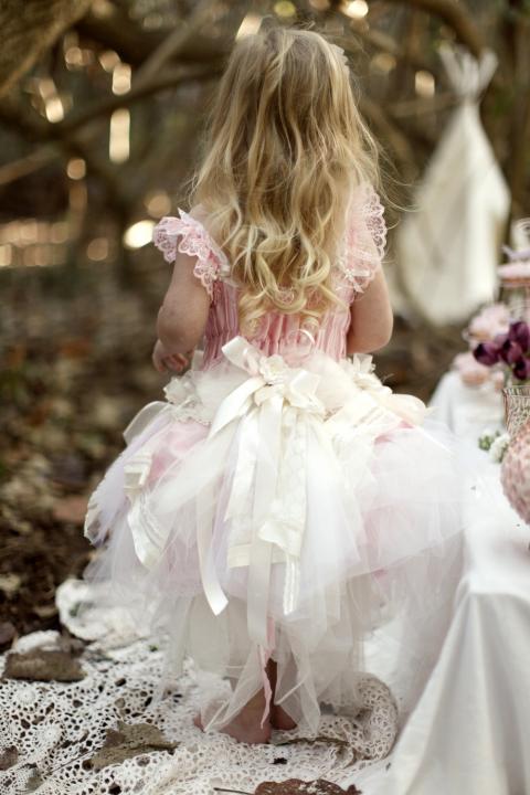 a pink and white midi A-line flower girl dress with a full skirt and lots of bows is a pretty and chic idea