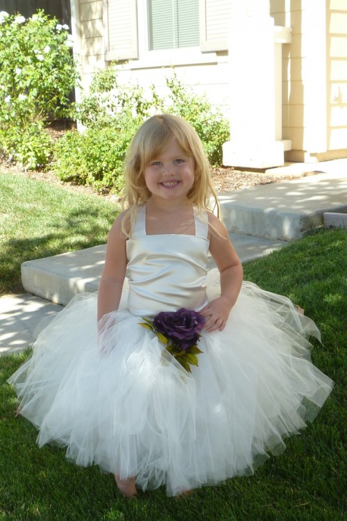 a neutral flower girl dress with a silky bodice, straps and a tulle skirt is a lovely idea with a cute touch