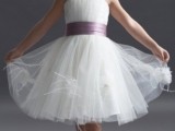 a white tulle knee dress with a lavender sash and wide straps for an airy and chic flower girl look