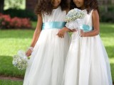white sleeveless A-line midi dresses with blue sashes, baby’s breath crowns and bouquets for lovely classic flower girl looks