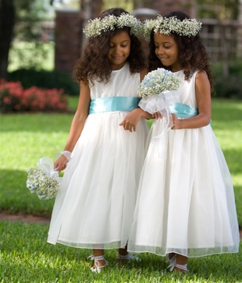 white sleeveless A-line midi dresses with blue sashes, baby's breath crowns and bouquets for lovely classic flower girl looks