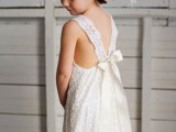 a white lace midi dress with an open back with straps and a bow is a cool piece for a boho wedding