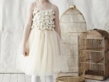 a neutral short vintage flower girl dress with a ruffle and embellished bodice and a tulle skirt for a vintage look