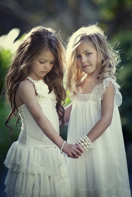 relaxed white flower girl dresses with lace, fabric flowers, ruffles are cool for a vintage or boho wedding