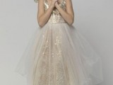 a lovely flower girl dress of a gold sequin underdress with no sleeves and a sheer overskirt is a very glam and chic look