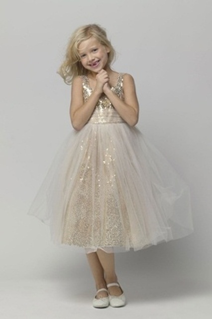 a lovely flower girl dress of a gold sequin underdress with no sleeves and a sheer overskirt is a very glam and chic look