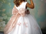 a white sleeveless a-line dress with a pink sash and bow, with floral prints is a beautiful and fairy-tale like idea