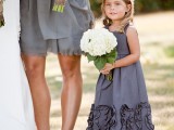 a grey A-line sleeveless flower girl dress with floral detailing is a stylish idea for a modern wedding