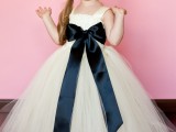 a tulle A-line flower girl dress with a black silk bow is a beautiful and pretty girlish idea to rock