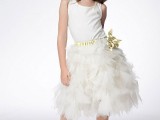 a white flower girl dress with a sleek sleeveless bodice and a feathered skirt plus a fabric floral sash