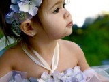 a lavender tulle flower girl dress with a fabric flower bodice and a matching floral crown is a chic and whimsical idea