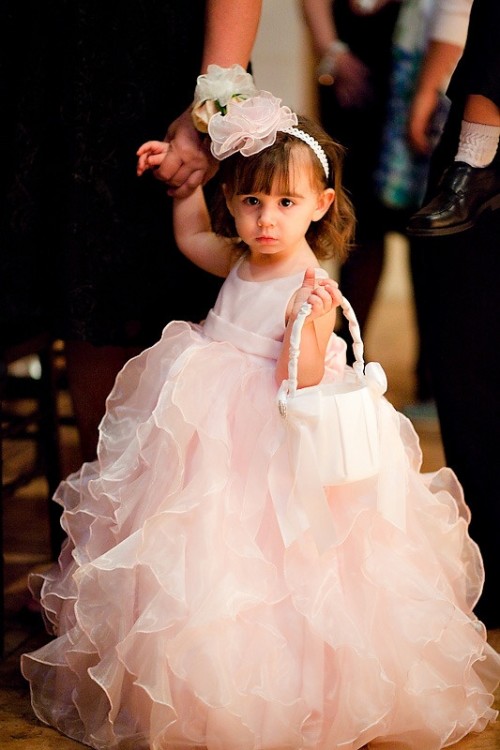 a light pink sleeveless A-line flower girl dress with a ruffle tiered skirt is a beautiful candy-like outfit