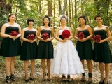black strapless A-line over the knee bridesmaid dresses paired with black shoes and red rose bouquets for a Halloween wedding