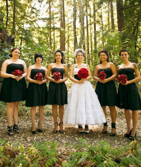 black strapless A line over the knee bridesmaid dresses paired with black shoes and red rose bouquets for a Halloween wedding