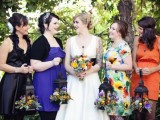 mismatching black, purple, orange and floral bridesmaid dresses to show each girl’s style and favorite color