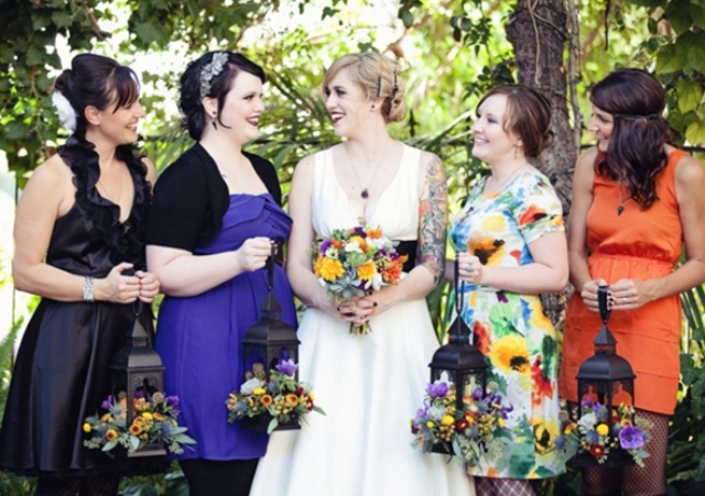 mismatching black, purple, orange and floral bridesmaid dresses to show each girl's style and favorite color
