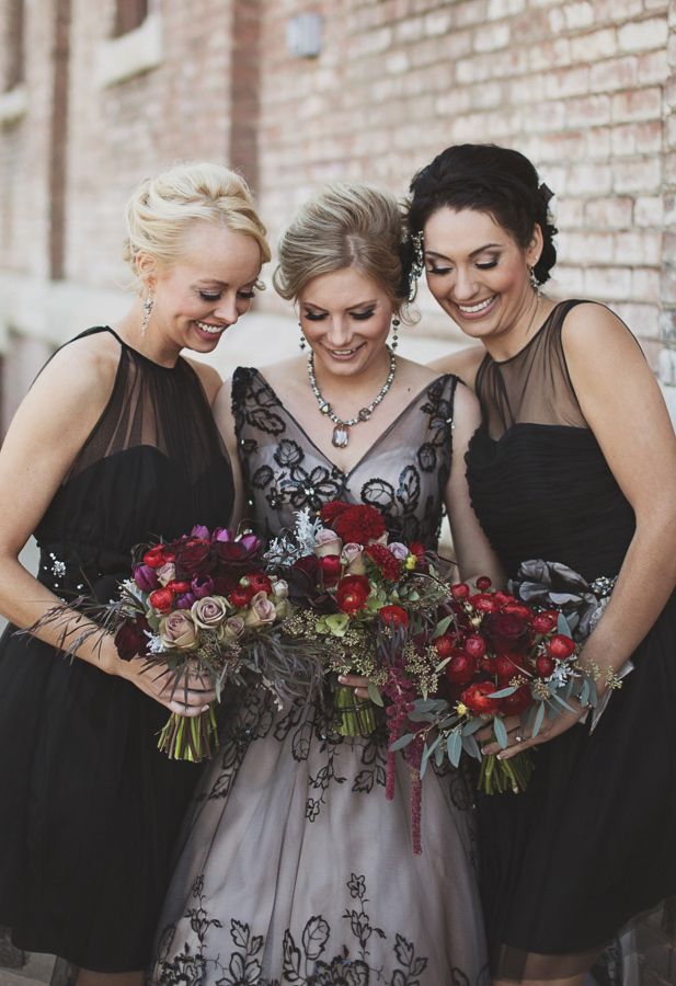 elegant midi black A line bridesmaid dresses with illusion necklines and draped fabric look chic and stylish at a Halloween wedding