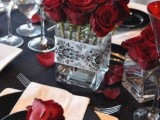 a stylish wedding centerpiece of red roses in a jar is a very cool and bold statement at the table