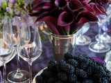 a shiny vase with deep purple callas is a chic and refined Halloween wedding centerpiece that looks very dramatic