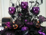 a dramatic black, purple and orange glitter Halloween wedding centerpiece with leaves, twigs and bats