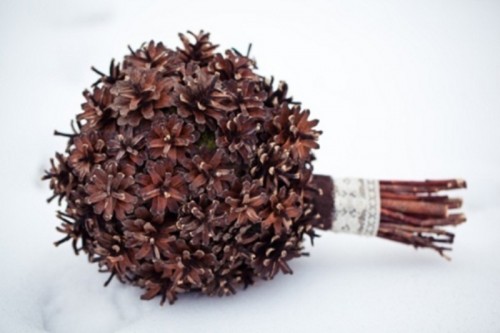 a stylish winter wedding bouquet of pinecones only and a chic ribbon wrap is non-typical and very cool