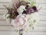 a romantic winter wedding bouquet done in blush, white, purple, green and with much dimension and texture