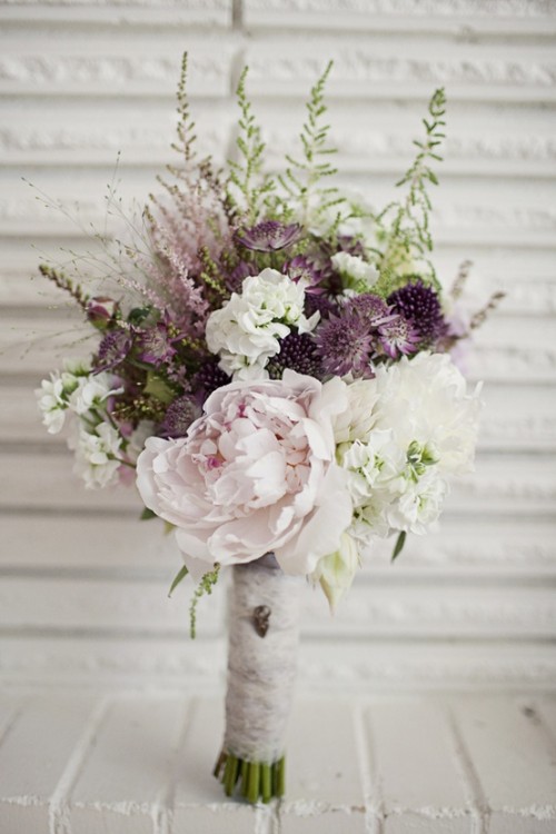 a romantic winter wedding bouquet done in blush, white, purple, green and with much dimension and texture