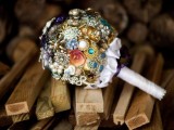 a colorful brooch wedding bouquet with a white ribbon wrap is a cool alternative to a usual one