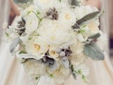 a pale winter wedding bouquet with pale greenery, white blooms and grey berries