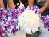 a white winter wedding bouquet of blooms and feathers is a cool idea for a soft and cool winter look
