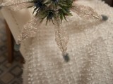 a bold winter wedding bouquet of thistles and shiny glitter snowflake elements is a unique idea