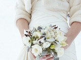 a white and pale winter wedding bouquet with blooms, cotton and foliage