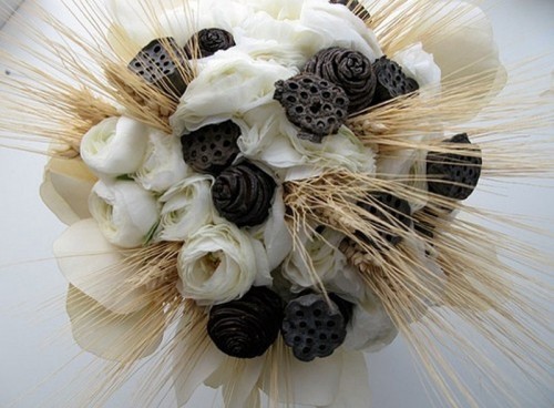 a creative winter wedding bouquet with white blooms, wheat, pinecones and dried elements for a winter wedding